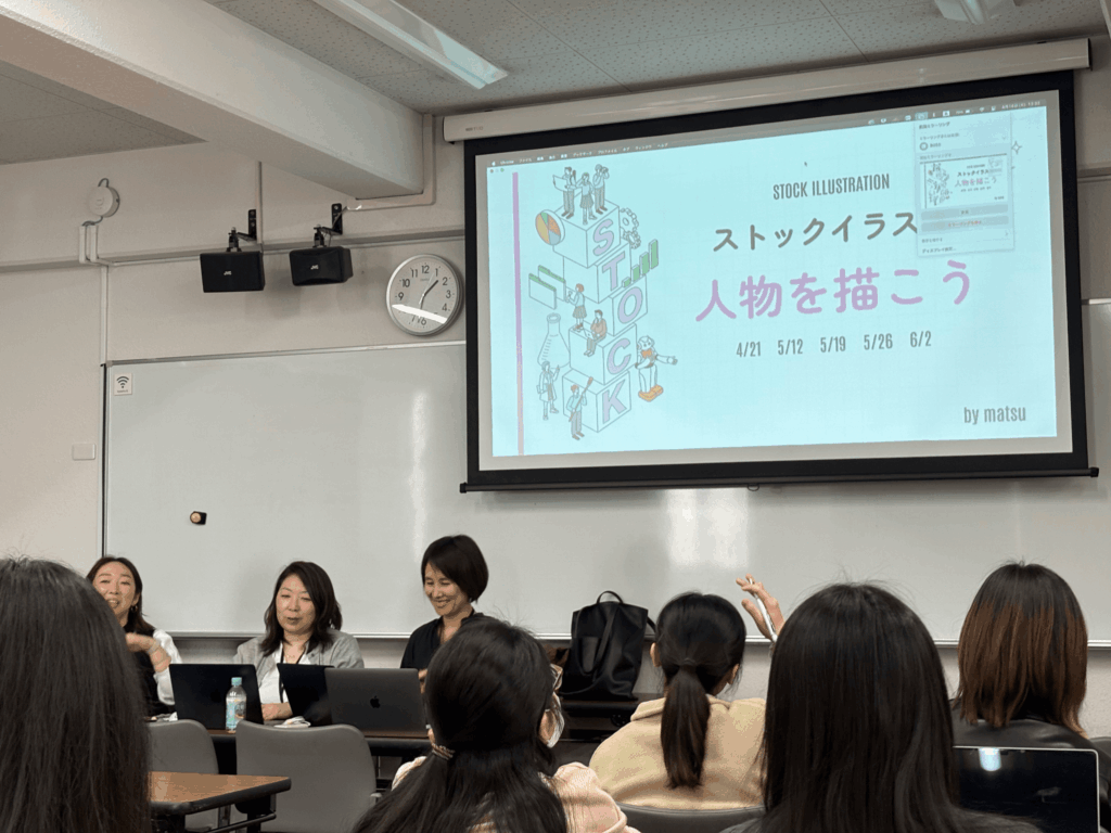 イラストレーション科イラストレーターコースの授業「ストックイラスト」を受ける学生と、3人の先生
教室前方のスクリーンには今後扱う課題「人物を描こう」の概要が表示されている